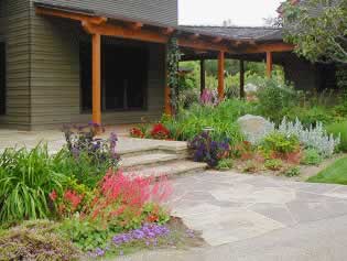 Rustic style, clean lines, and repetition of color scheme allow the porch to connect the home with the garden.